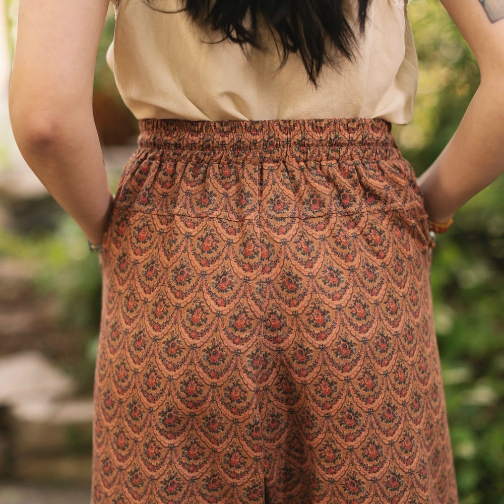 
                  
                    Model wearing Peace, Wine & Sunshine Bohéme Slip Dress featuring botanical collages and playful peace, wine and sunshine lettering on the hem – Market of Stars.
                  
                