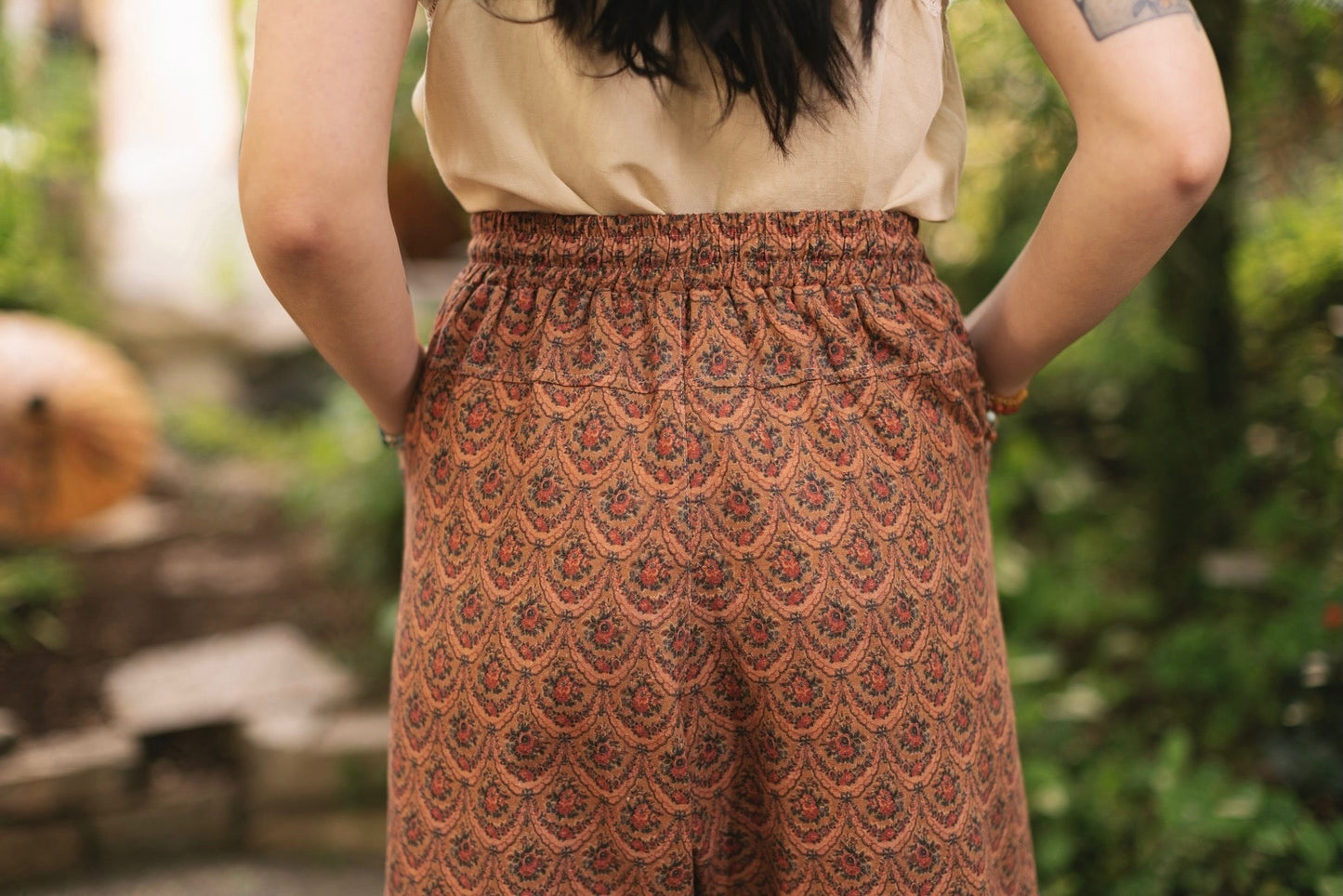 Model wearing Peace, Wine & Sunshine Bohéme Slip Dress featuring botanical collages and playful peace, wine and sunshine lettering on the hem – Market of Stars.