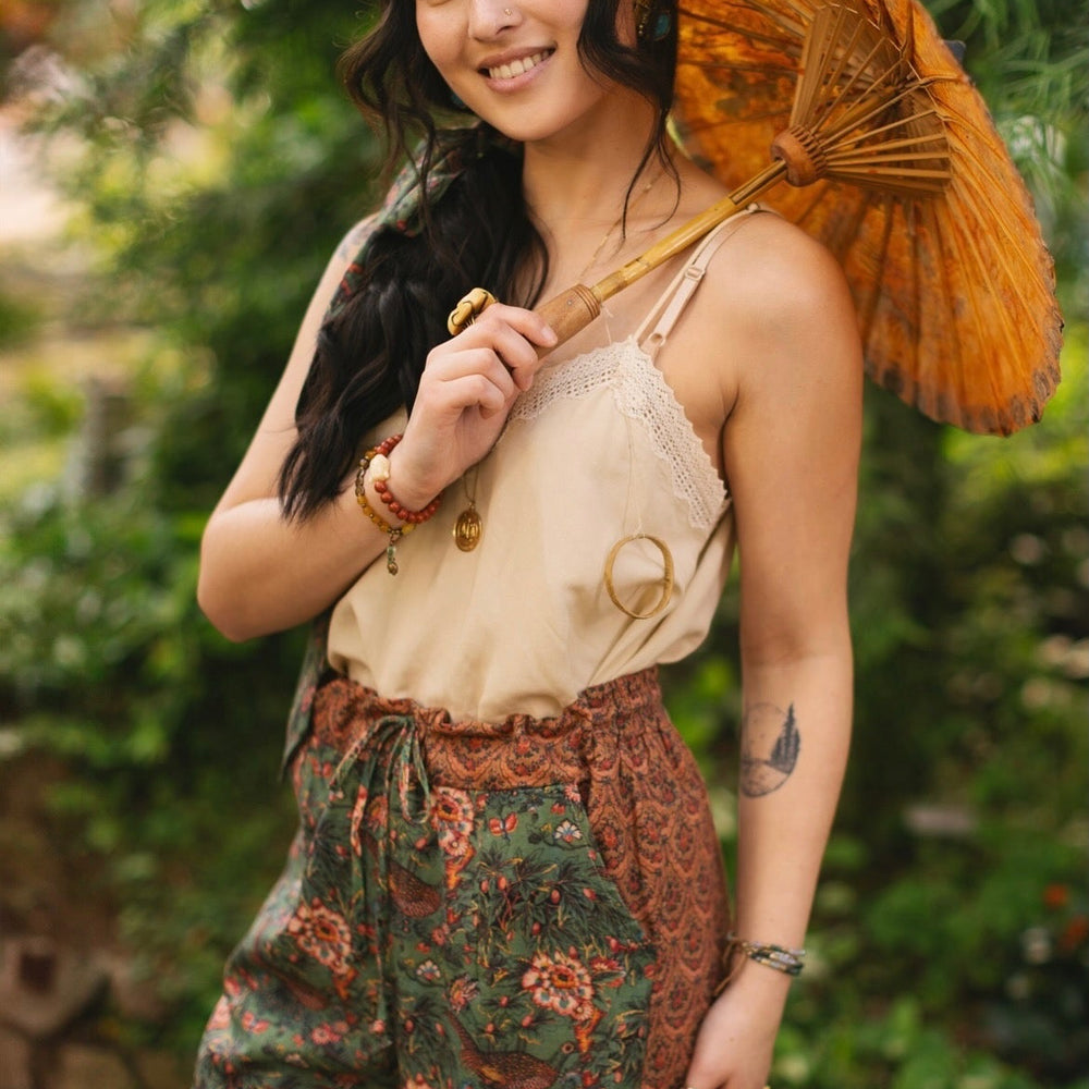 
                  
                    Model wearing Peace, Wine & Sunshine Bohéme Slip Dress featuring botanical collages and playful peace, wine and sunshine lettering on the hem – Market of Stars.
                  
                