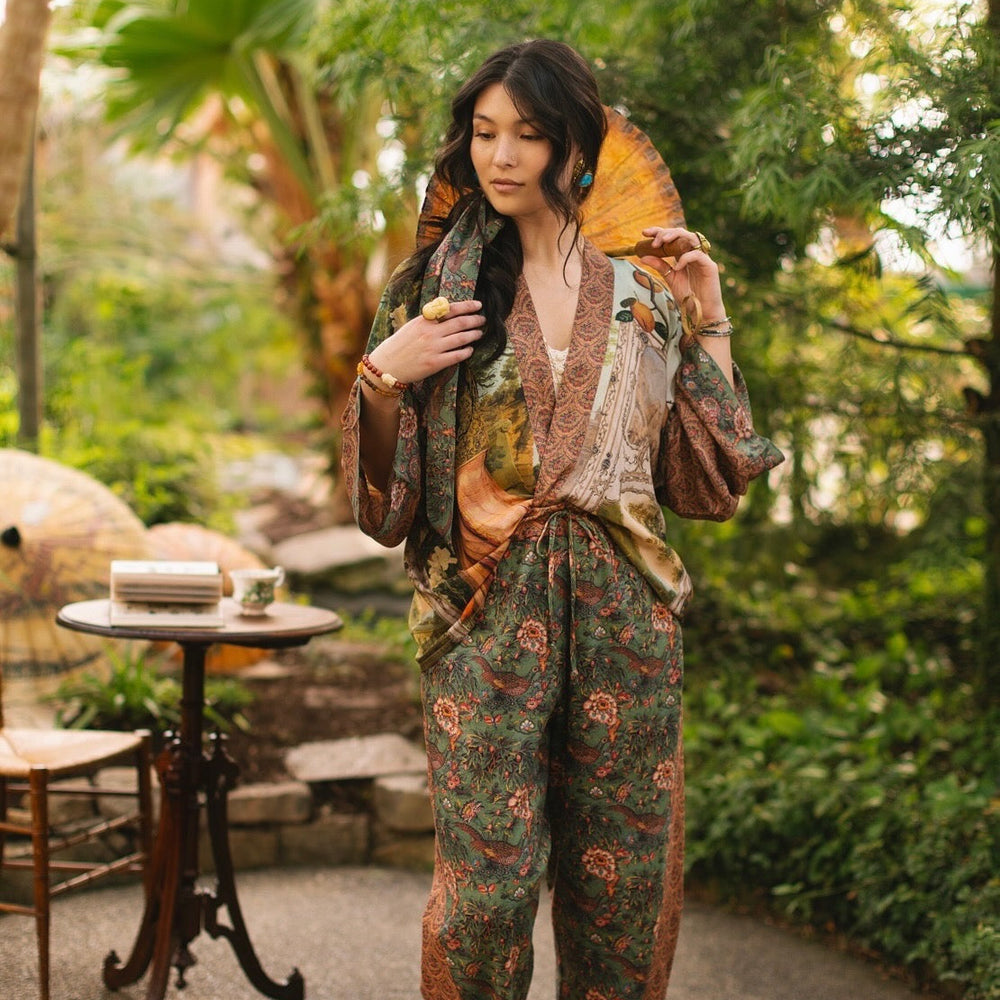 
                  
                    Model wearing Peace, Wine & Sunshine Bohéme Slip Dress featuring botanical collages and playful peace, wine and sunshine lettering on the hem – Market of Stars.
                  
                
