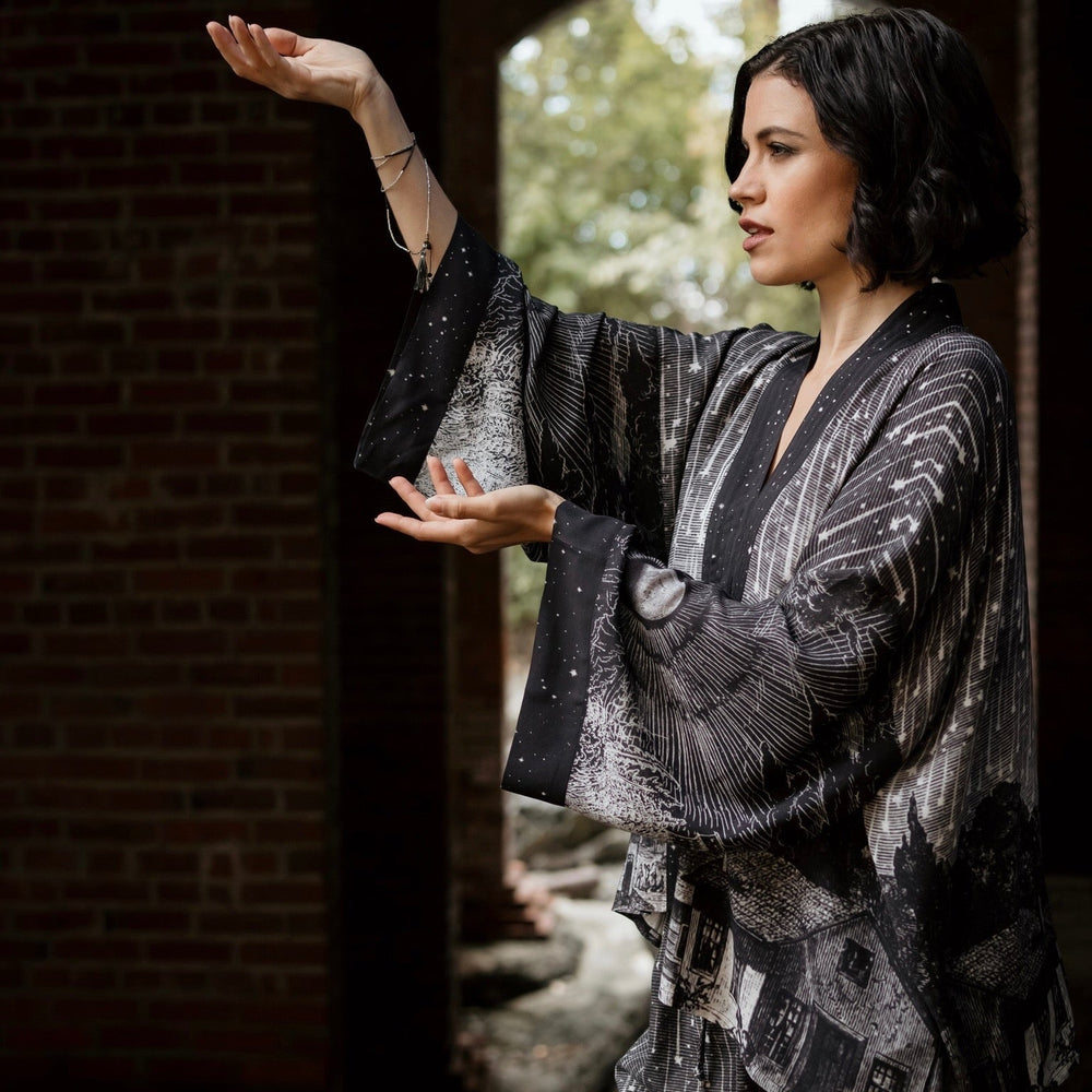 
                  
                    Model wearing our Stargazer cropped kimono featuring an antique engraving of a meteor shower and moonlit astronomy imagery – Market of Stars
                  
                