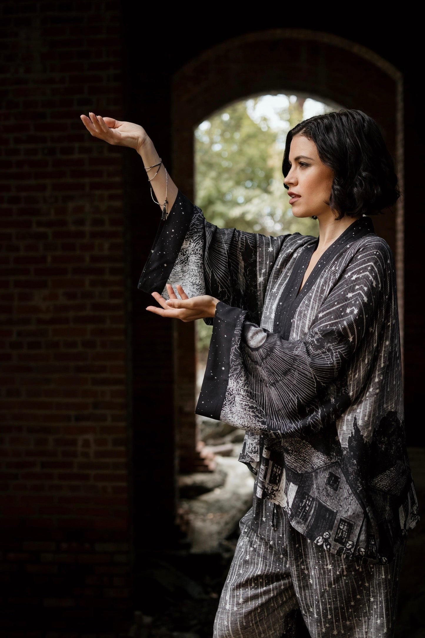 Model wearing our Stargazer cropped kimono featuring an antique engraving of a meteor shower and moonlit astronomy imagery – Market of Stars