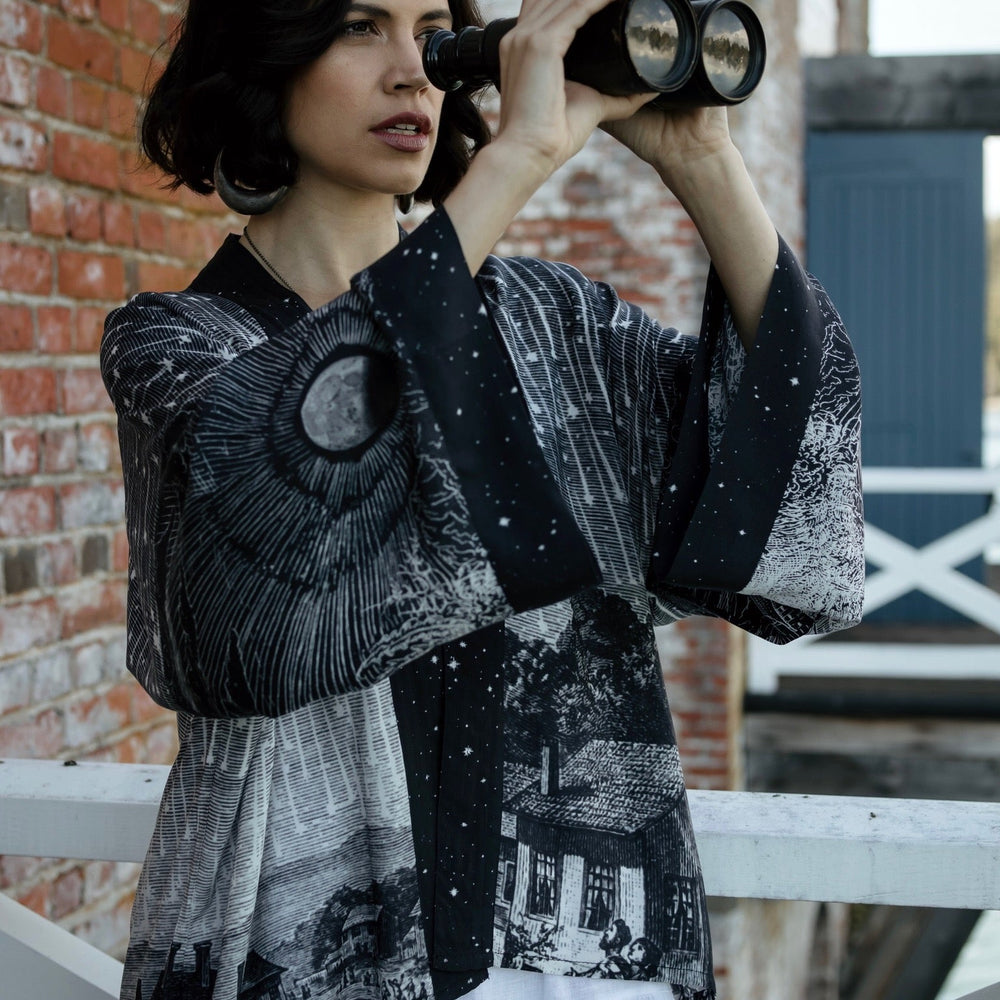 
                  
                    Model wearing our Stargazer cropped kimono featuring an antique engraving of a meteor shower and moonlit astronomy imagery – Market of Stars
                  
                