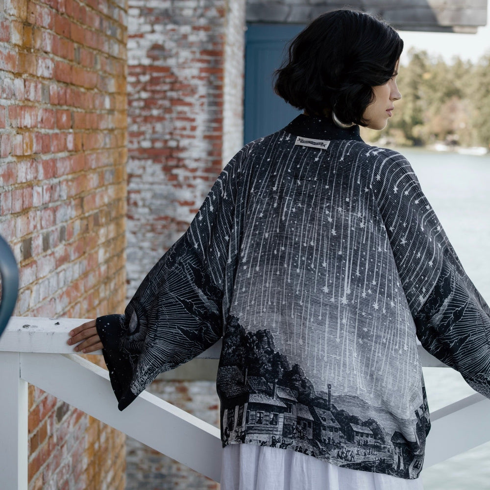 
                  
                    Model wearing our Stargazer cropped kimono featuring an antique engraving of a meteor shower and moonlit astronomy imagery – Market of Stars
                  
                