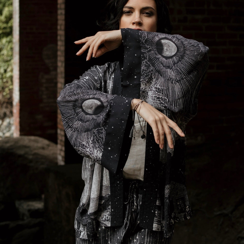 
                  
                    Model wearing our Stargazer cropped kimono featuring an antique engraving of a meteor shower and moonlit astronomy imagery – Market of Stars
                  
                