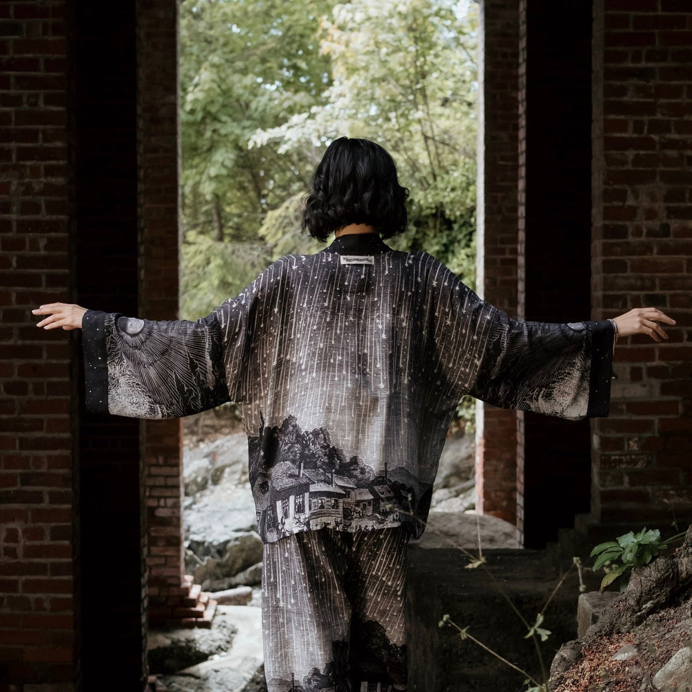 
                  
                    Model wearing our Stargazer cropped kimono featuring an antique engraving of a meteor shower and moonlit astronomy imagery – Market of Stars
                  
                