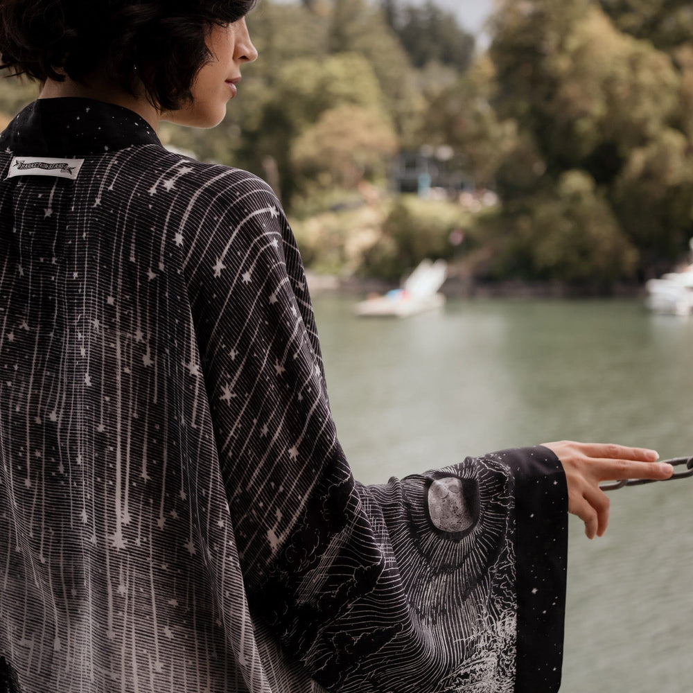 
                  
                    Model wearing our Stargazer cropped kimono featuring an antique engraving of a meteor shower and moonlit astronomy imagery – Market of Stars
                  
                
