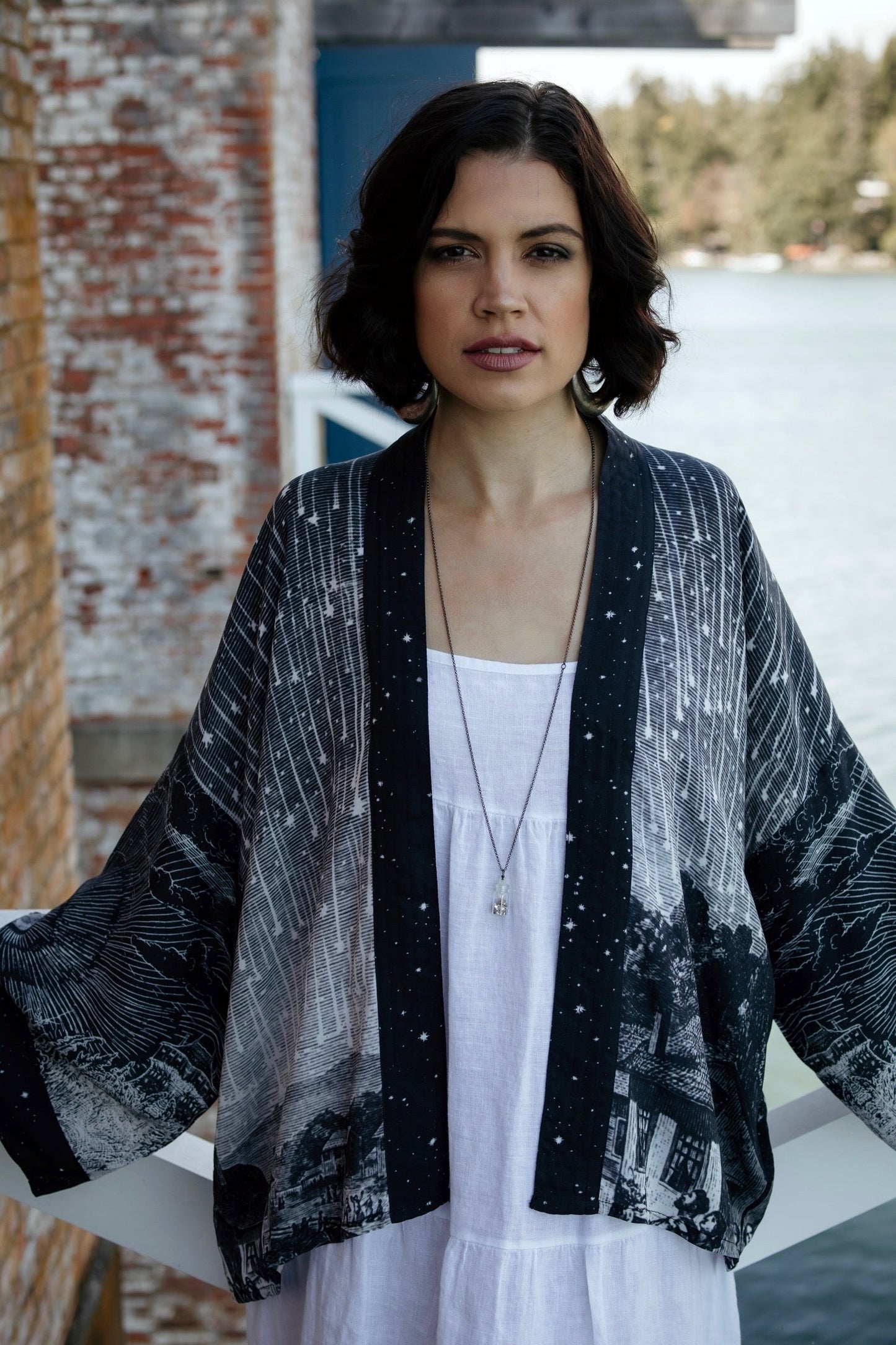 Model wearing our Stargazer cropped kimono featuring an antique engraving of a meteor shower and moonlit astronomy imagery – Market of Stars