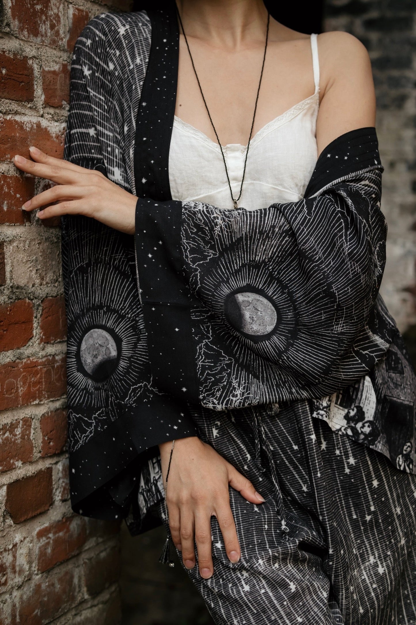Model wearing our Stargazer cropped kimono featuring an antique engraving of a meteor shower and moonlit astronomy imagery – Market of Stars