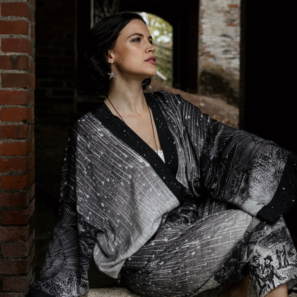 
                  
                    Model wearing our Stargazer cropped kimono featuring an antique engraving of a meteor shower and moonlit astronomy imagery – Market of Stars
                  
                