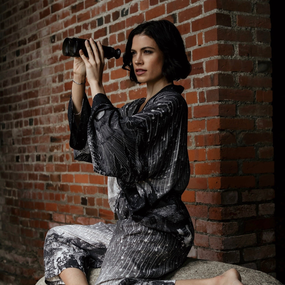 
                  
                    Model wearing Peace, Wine & Sunshine Bohéme Slip Dress featuring botanical collages and playful peace, wine and sunshine lettering on the hem – Market of Stars.
                  
                