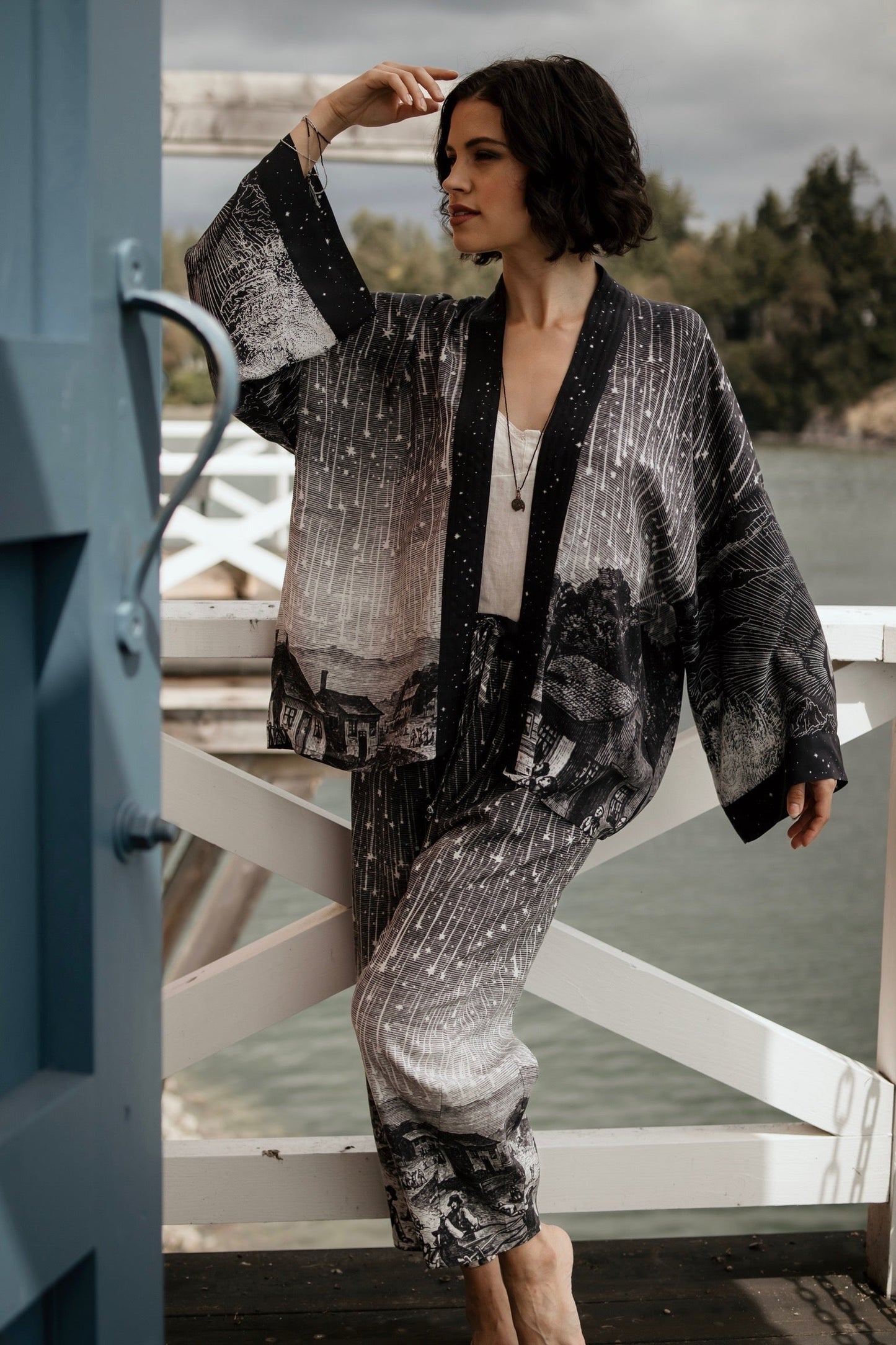 Model wearing Peace, Wine & Sunshine Bohéme Slip Dress featuring botanical collages and playful peace, wine and sunshine lettering on the hem – Market of Stars.