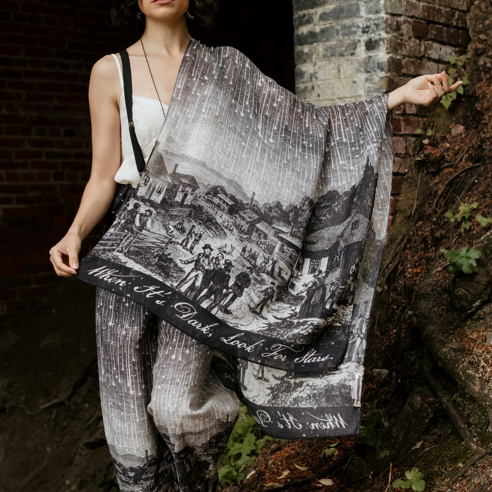 Model wearing the Stargazer Scarf featuring antique night sky illustrations and the quote "When it's dark, look for stars" – Market of Stars