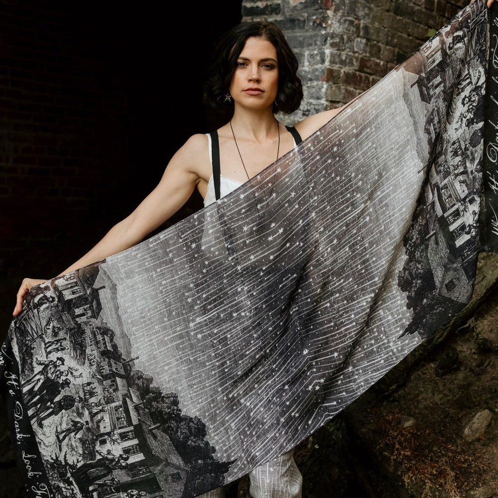 
                  
                    Model wearing the Stargazer Scarf featuring antique night sky illustrations and the quote "When it's dark, look for stars" – Market of Stars
                  
                