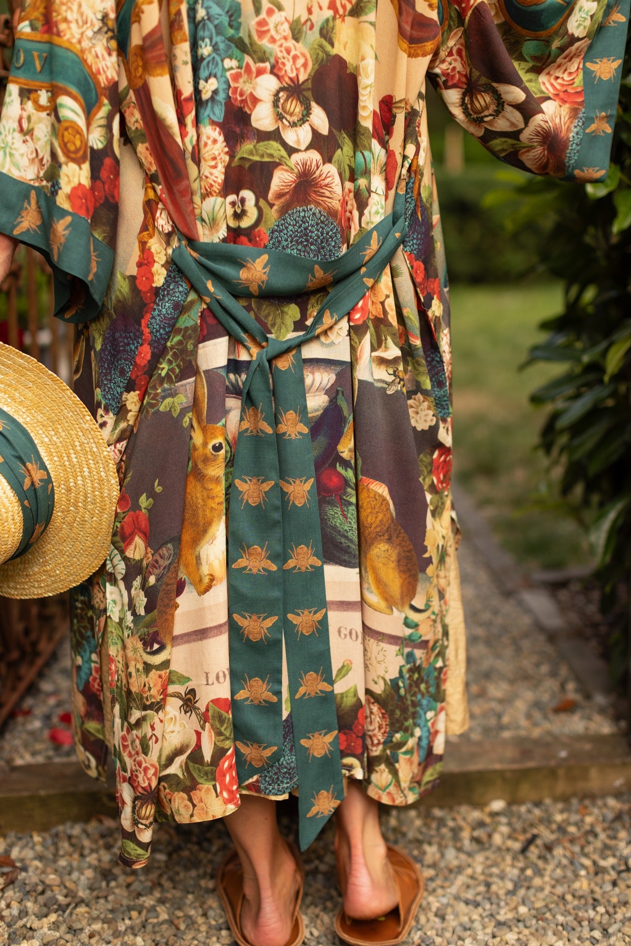 Model wearing Stay Gold Opera Duster with wildflower, bee, and bunny rabbit illustrations, golden script, and vintage collage in full-length kimono silhouette – Market of Stars