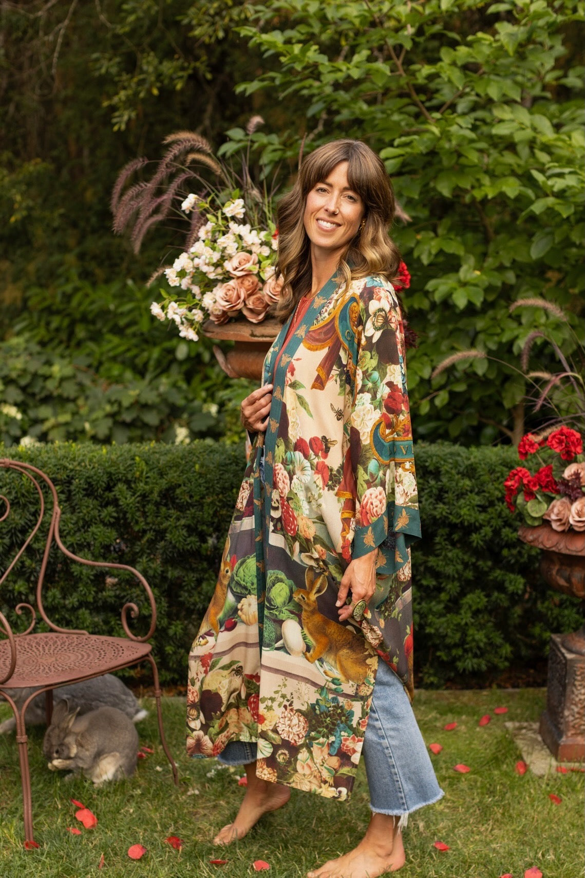 Model wearing Stay Gold Opera Duster with wildflower, bee, and bunny rabbit illustrations, golden script, and vintage collage in full-length kimono silhouette – Market of Stars