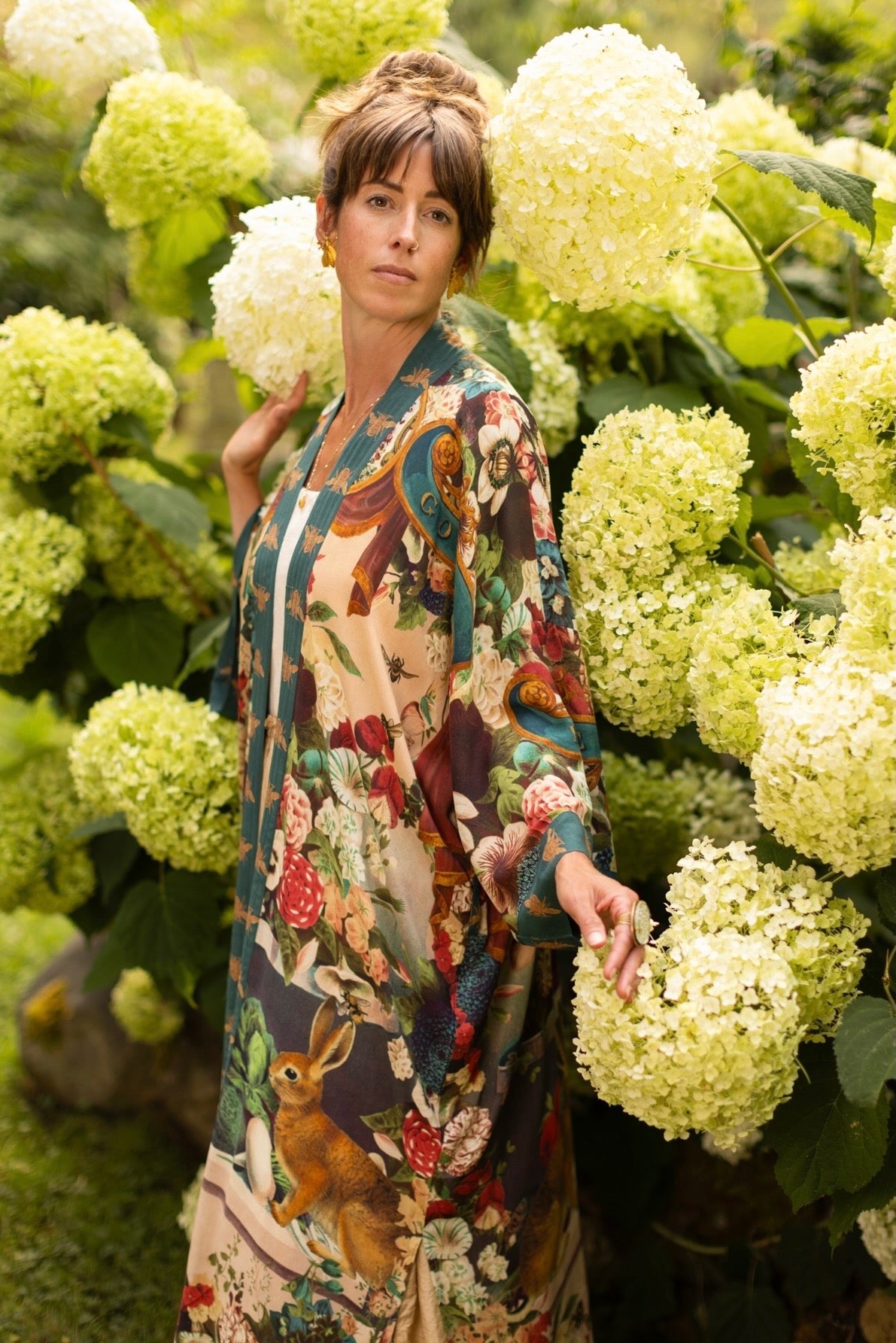 Model wearing Stay Gold Opera Duster with wildflower, bee, and bunny rabbit illustrations, golden script, and vintage collage in full-length kimono silhouette – Market of Stars