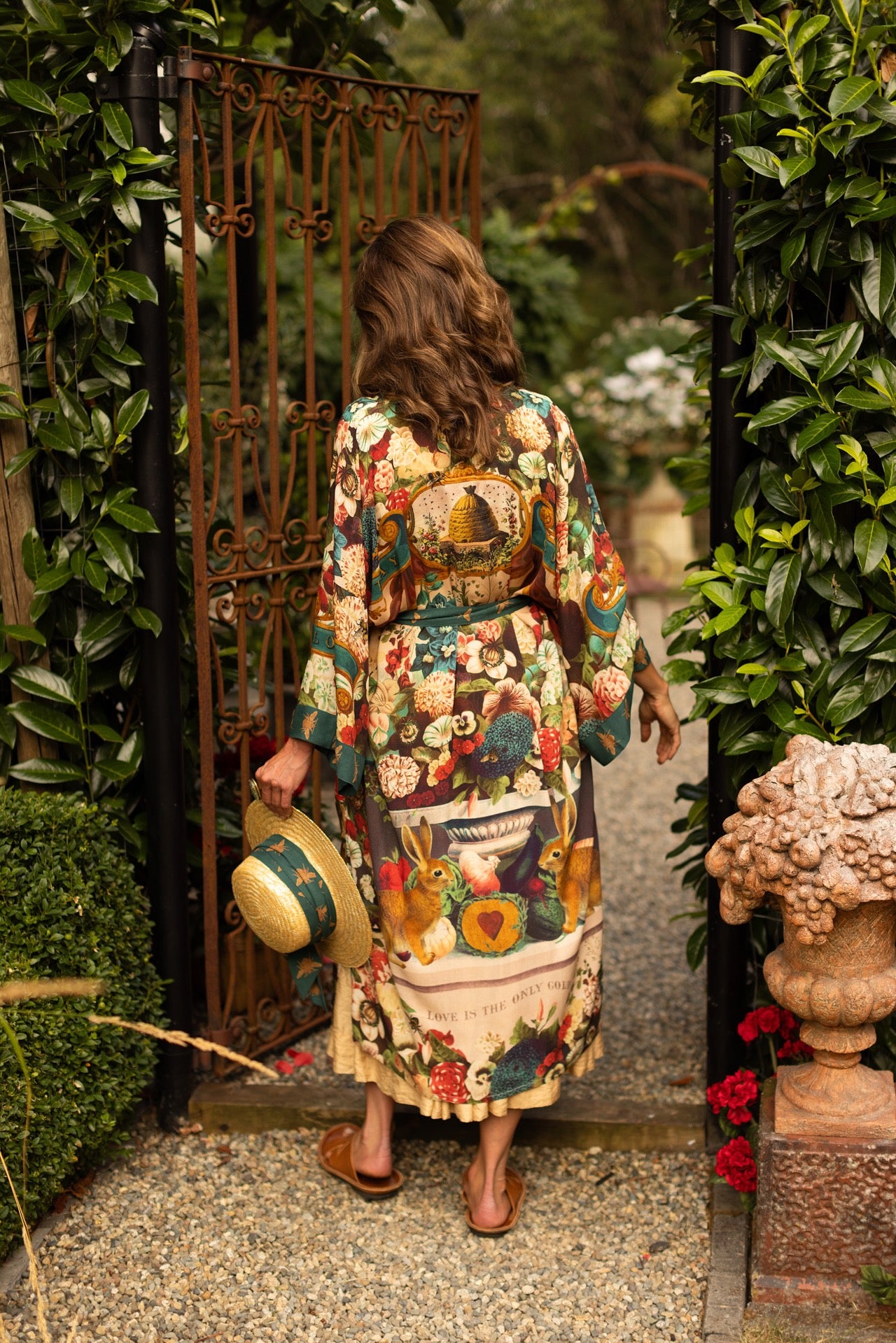Model wearing Stay Gold Opera Duster with wildflower, bee, and bunny rabbit illustrations, golden script, and vintage collage in full-length kimono silhouette – Market of Stars