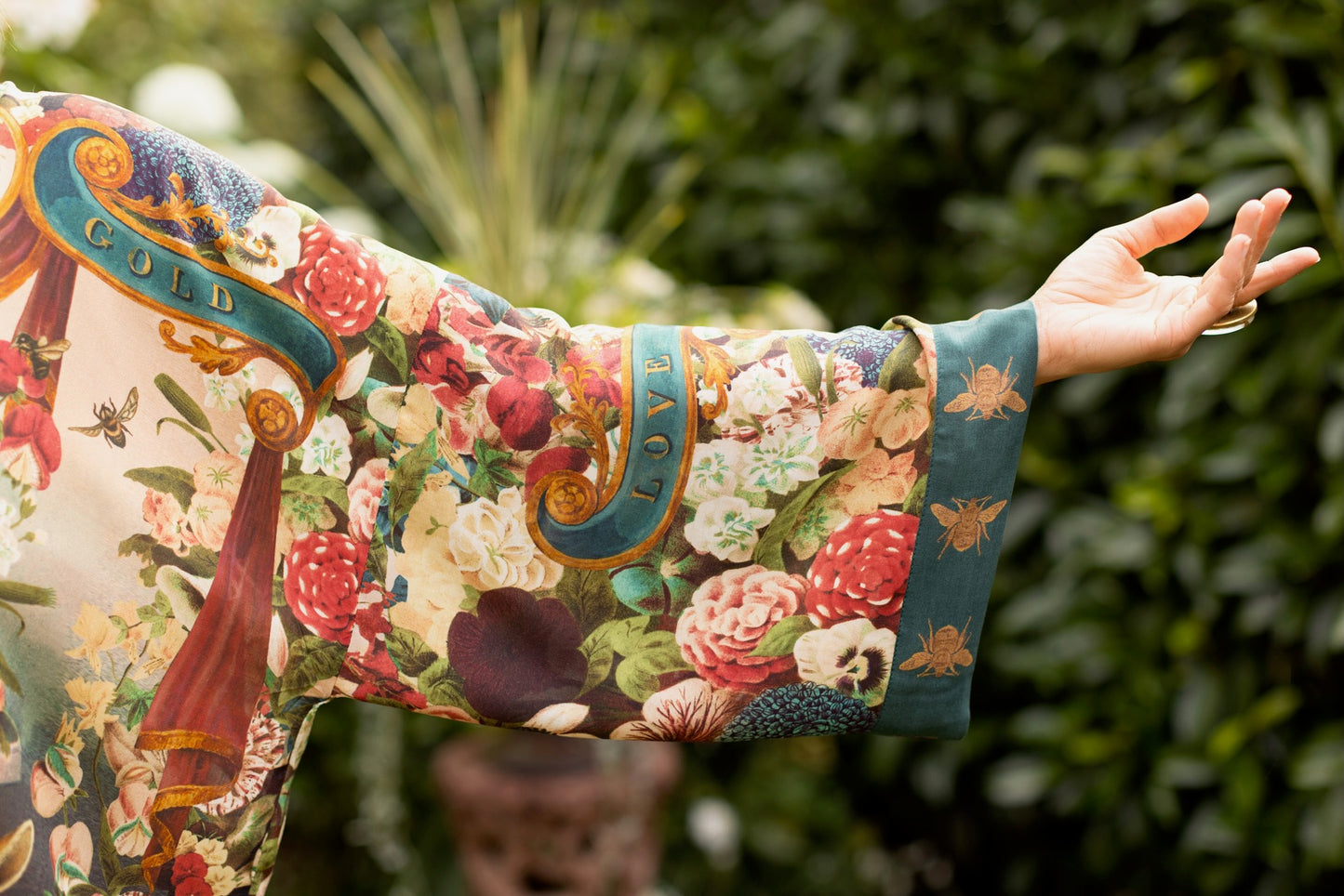 Model wearing Stay Gold Opera Duster with wildflower, bee, and bunny rabbit illustrations, golden script, and vintage collage in full-length kimono silhouette – Market of Stars