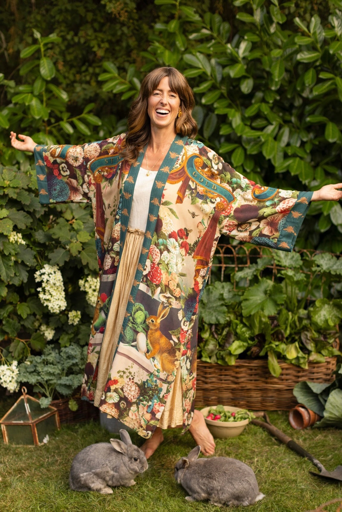 Model wearing Stay Gold Opera Duster with wildflower, bee, and bunny rabbit illustrations, golden script, and vintage collage in full-length kimono silhouette – Market of Stars