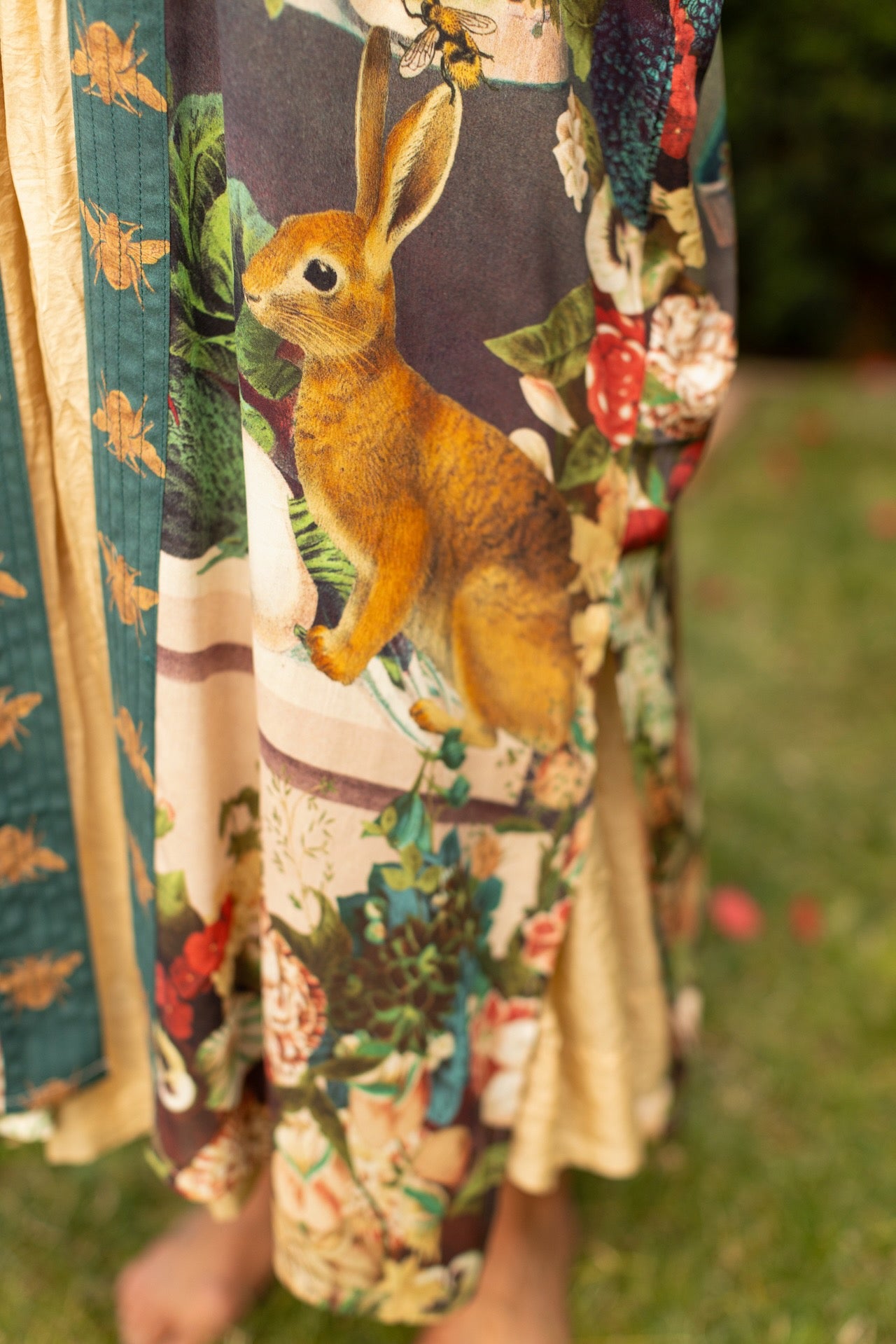 Model wearing Stay Gold Opera Duster with wildflower, bee, and bunny rabbit illustrations, golden script, and vintage collage in full-length kimono silhouette – Market of Stars