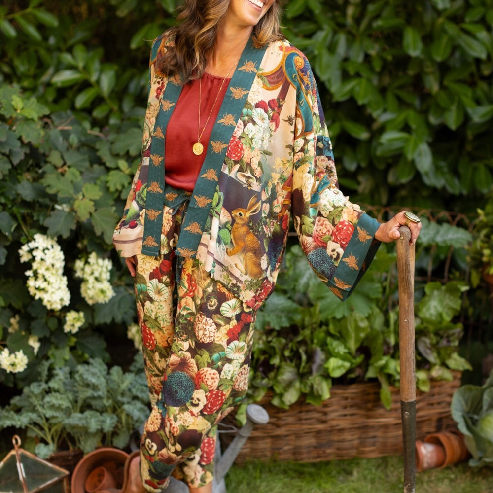 
                  
                    Model wearing Stay Gold linen Artist Pants with lantern hem and floral collage featuring vintage wildflower, bee, and rabbit illustrations – Market of Stars
                  
                