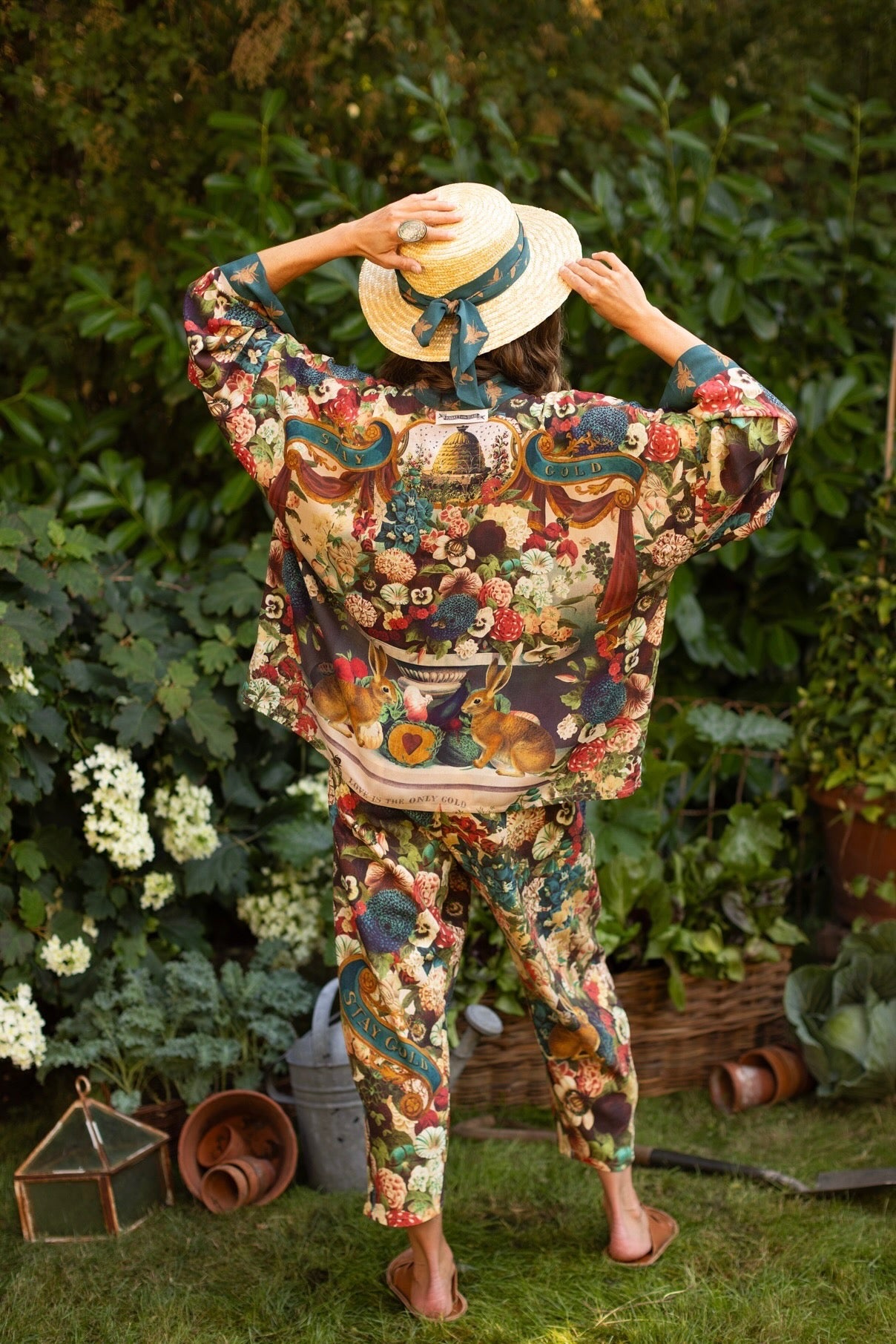 Model wearing Stay Gold Pixie Duster featuring wildflowers, bees, bunny rabbits and poetic vintage collage in cropped length – Market of Stars