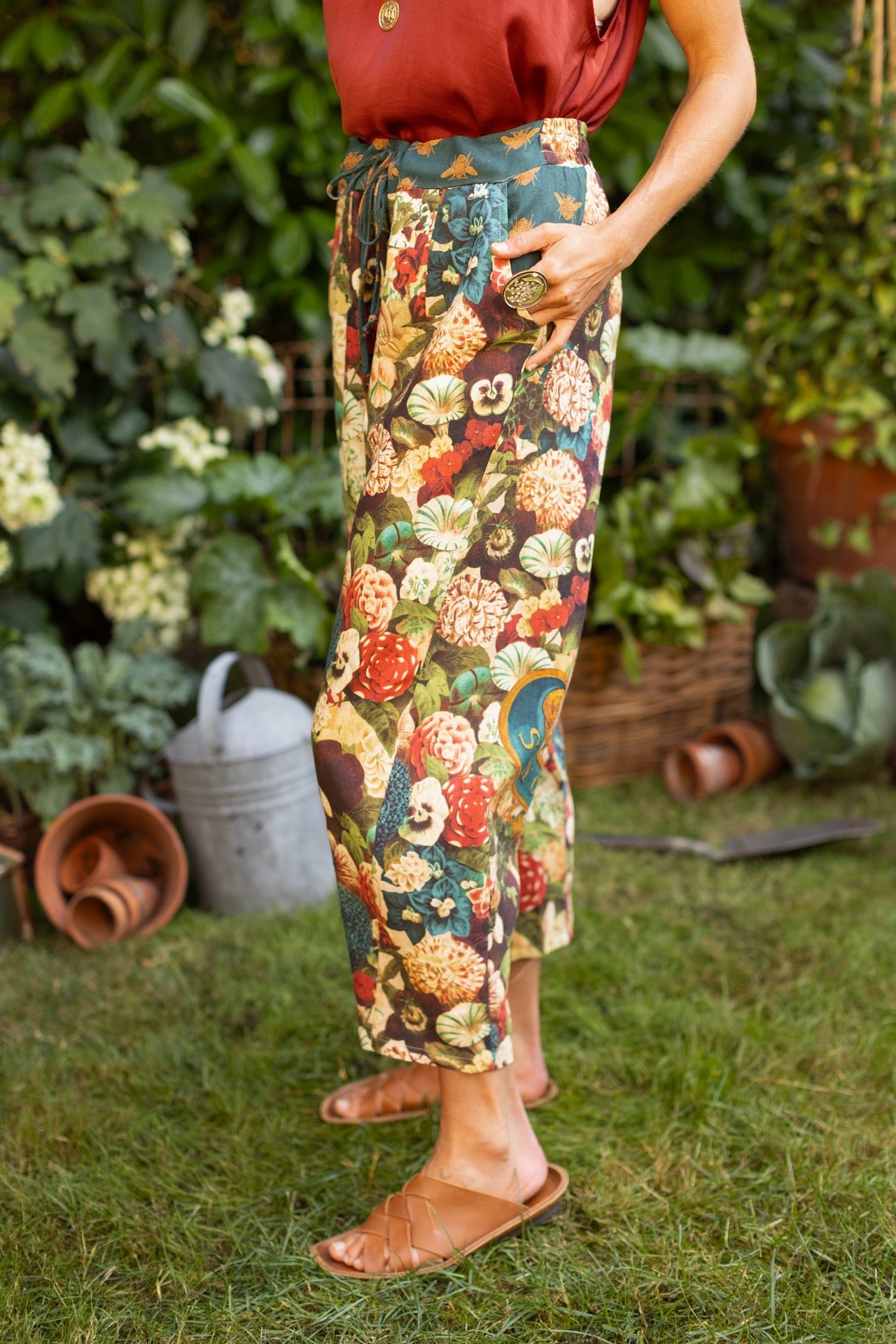 Model wearing Stay Gold linen Artist Pants with lantern hem and floral collage featuring vintage wildflower, bee, and rabbit illustrations – Market of Stars