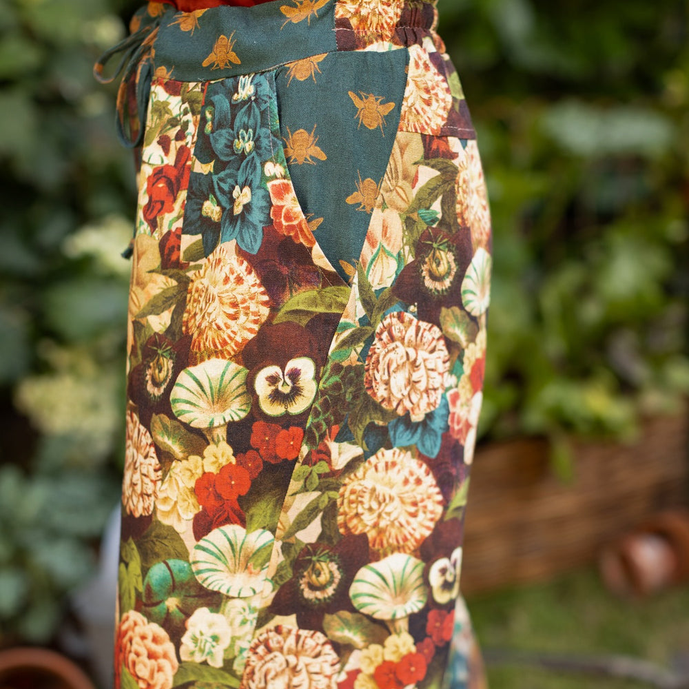 
                  
                    Model wearing Stay Gold linen Artist Pants with lantern hem and floral collage featuring vintage wildflower, bee, and rabbit illustrations – Market of Stars
                  
                