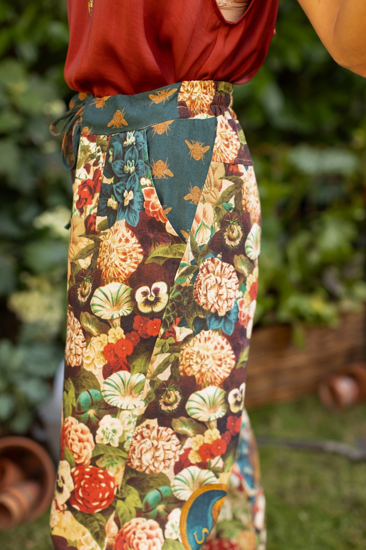 Model wearing Stay Gold linen Artist Pants with lantern hem and floral collage featuring vintage wildflower, bee, and rabbit illustrations – Market of Stars