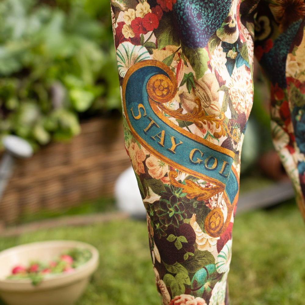 
                  
                    Model wearing Stay Gold linen Artist Pants with lantern hem and floral collage featuring vintage wildflower, bee, and rabbit illustrations – Market of Stars
                  
                