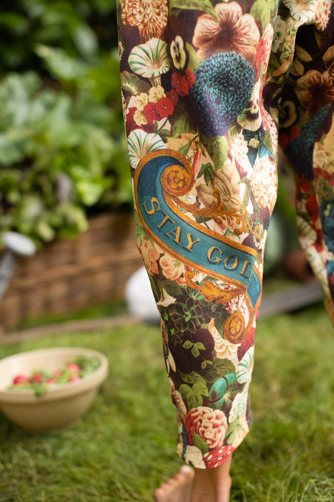 Model wearing Stay Gold linen Artist Pants with lantern hem and floral collage featuring vintage wildflower, bee, and rabbit illustrations – Market of Stars