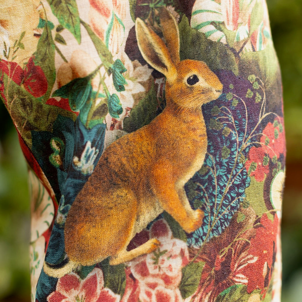 
                  
                    Model wearing Stay Gold linen Artist Pants with lantern hem and floral collage featuring vintage wildflower, bee, and rabbit illustrations – Market of Stars
                  
                