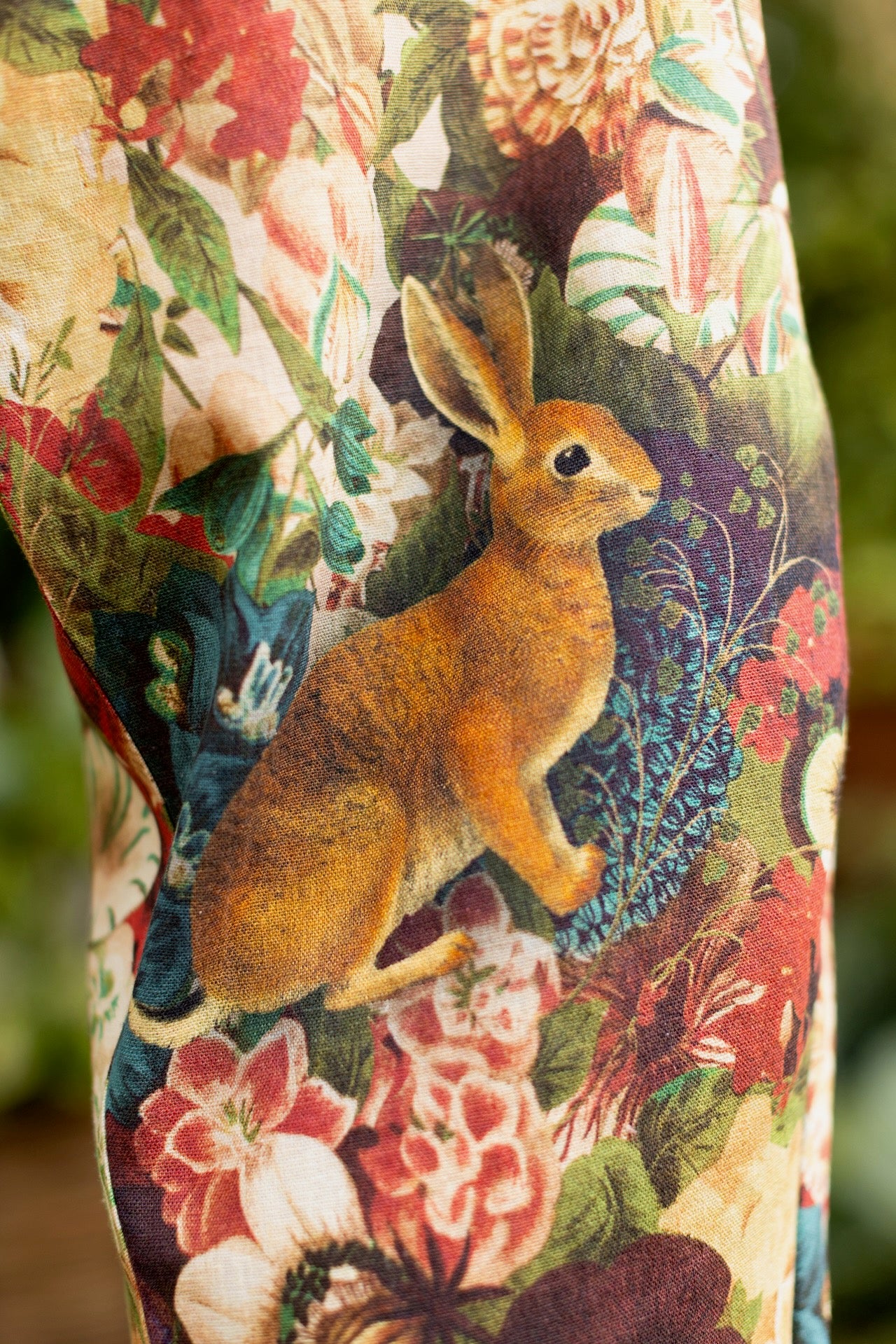 Model wearing Stay Gold linen Artist Pants with lantern hem and floral collage featuring vintage wildflower, bee, and rabbit illustrations – Market of Stars