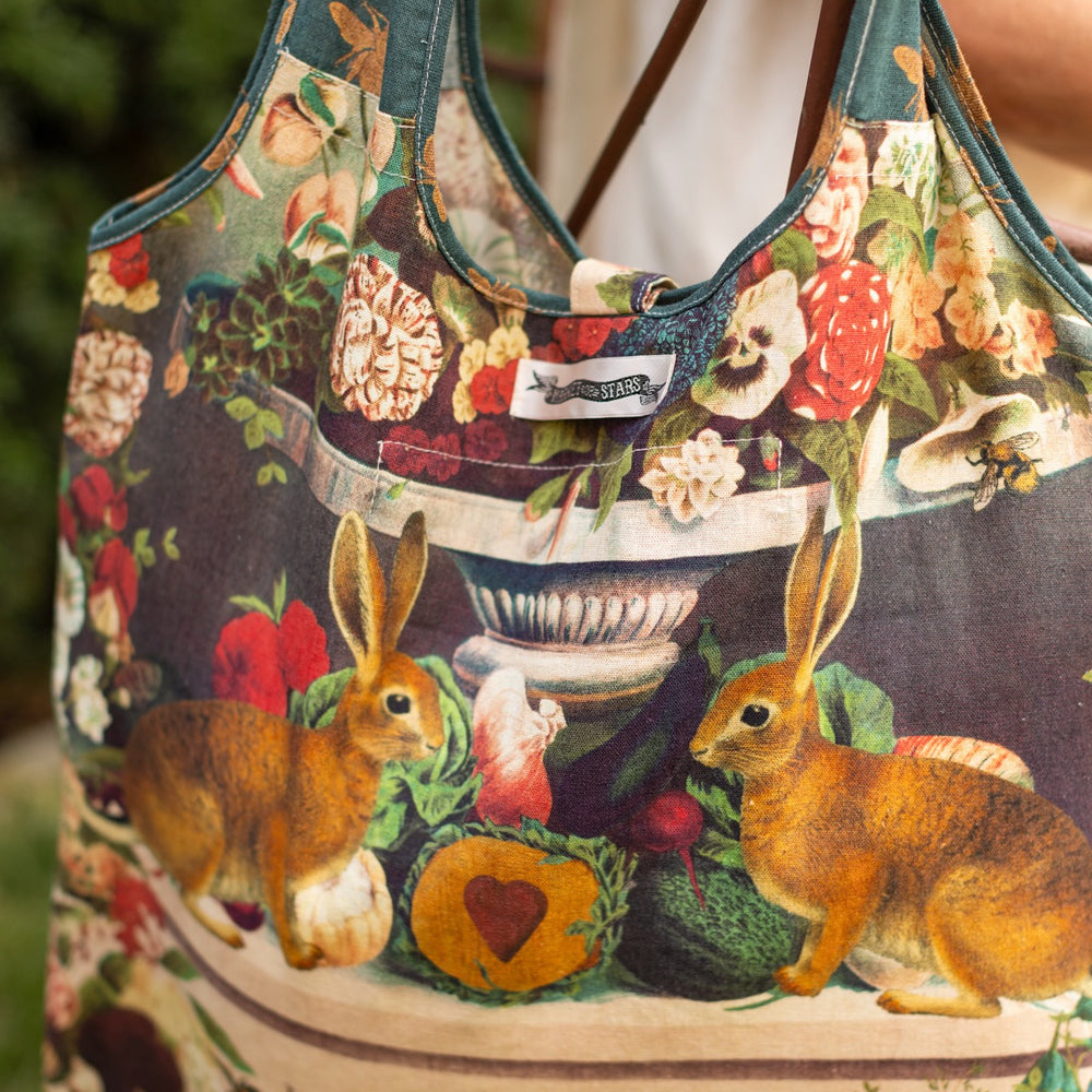 
                  
                    Stay Gold Market Tote featuring a vibrant vintage-inspired wildflower collage with bunny rabbits and bumblebees in a sturdy cotton canvas design – Market of Stars
                  
                