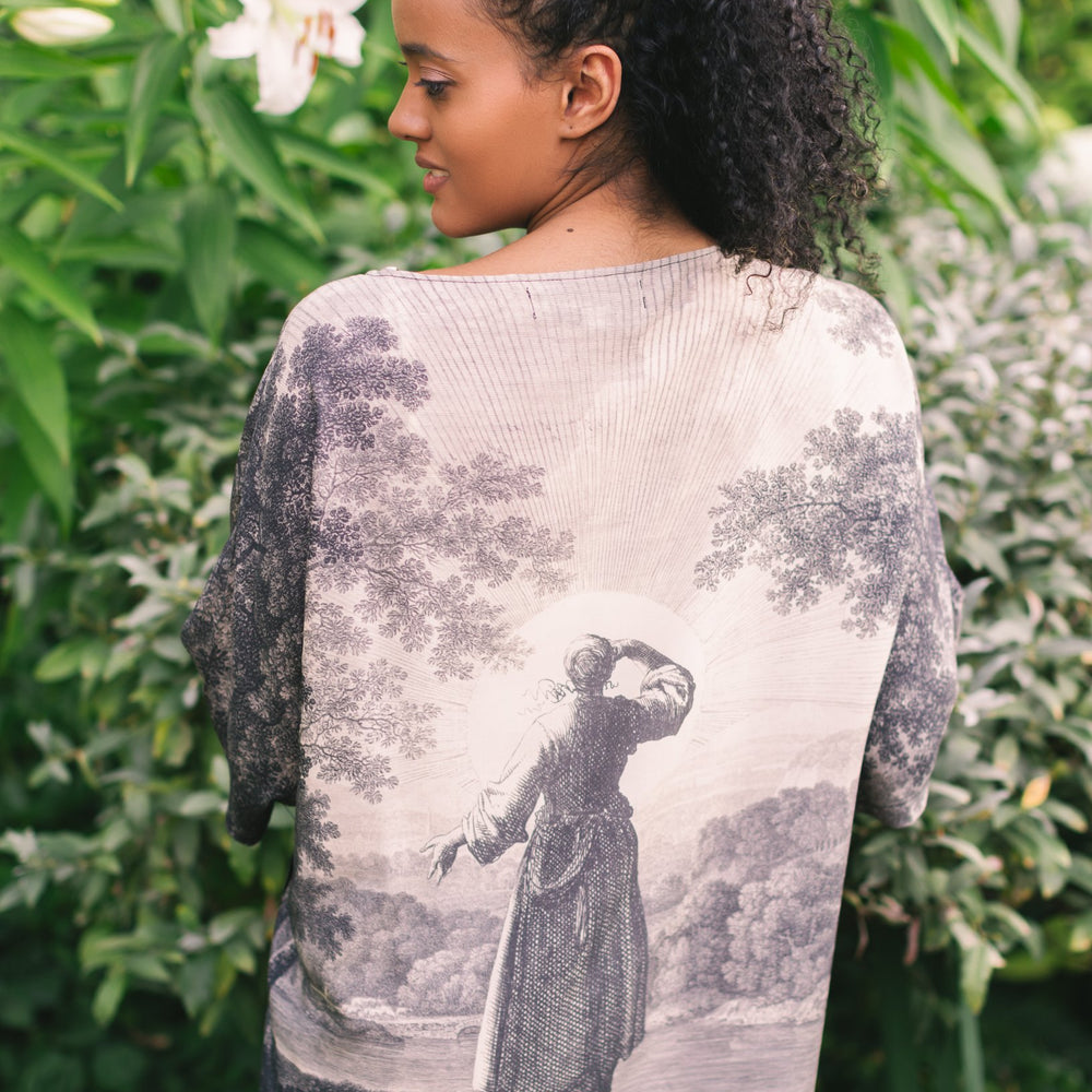 Model wearing the Still I Rise Luxe Tee with wide scoop neck and soft bamboo-based viscose, featuring vintage landscape etching and an inspiring message – Market of Stars