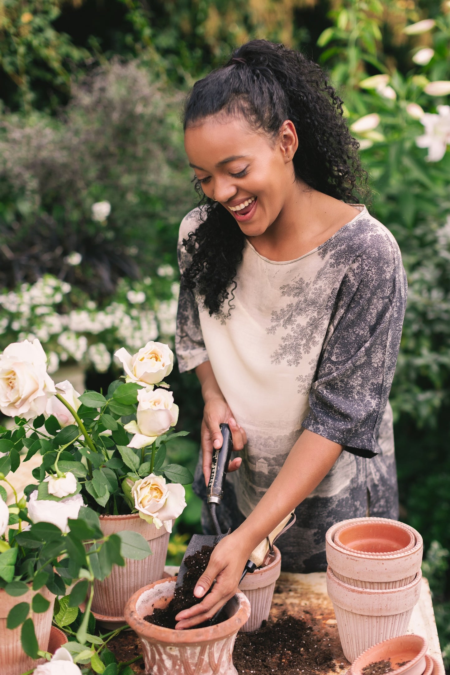 Model wearing the Still I Rise Luxe Tee with wide scoop neck and soft bamboo-based viscose, featuring vintage landscape etching and an inspiring message – Market of Stars