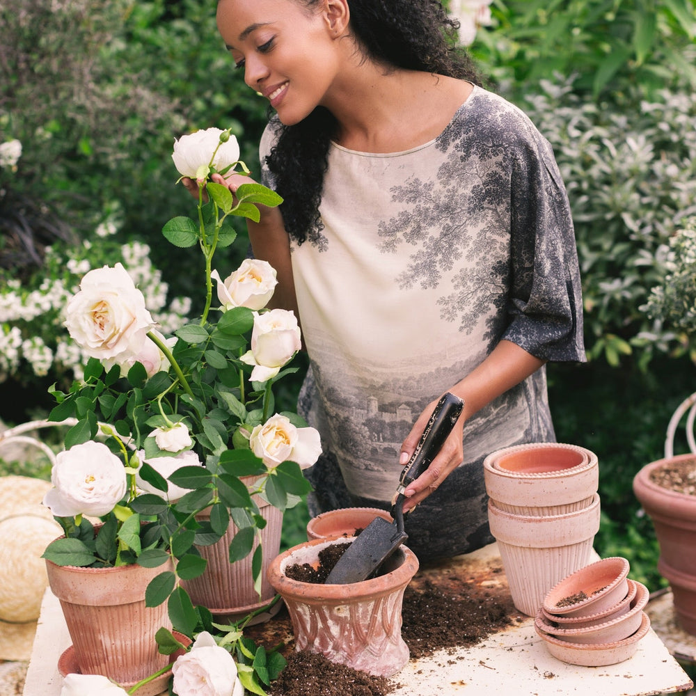 
                  
                    Model wearing the Still I Rise Luxe Tee with wide scoop neck and soft bamboo-based viscose, featuring vintage landscape etching and an inspiring message – Market of Stars
                  
                