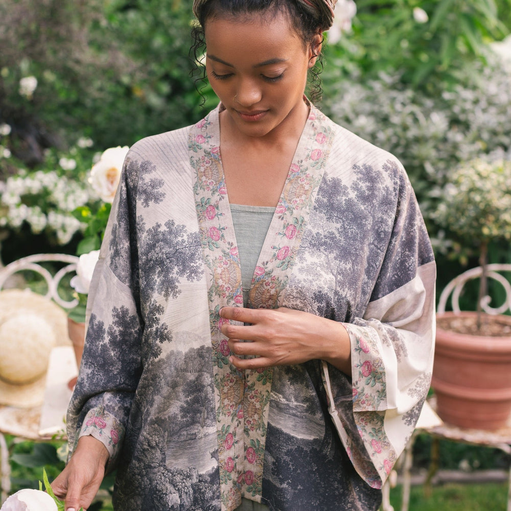 
                  
                    Model wearing our Still I Rise Pixie Duster with empowering message a bold, layered design featuring antique landscape etchings – Market of Stars
                  
                