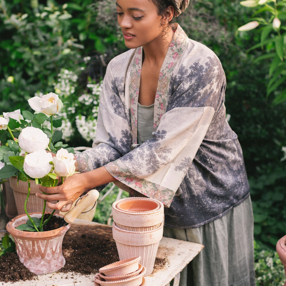 
                  
                    Model wearing our Still I Rise Pixie Duster with empowering message a bold, layered design featuring antique landscape etchings – Market of Stars
                  
                