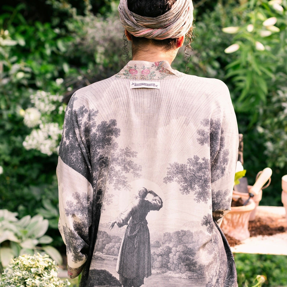 
                  
                    Model wearing our Still I Rise Pixie Duster with empowering message a bold, layered design featuring antique landscape etchings – Market of Stars
                  
                