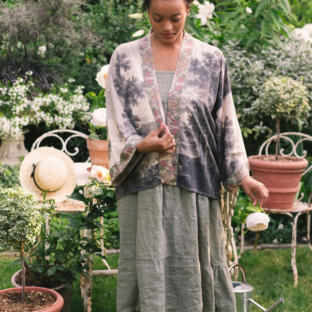 
                  
                    Model wearing our Still I Rise Pixie Duster with empowering message a bold, layered design featuring antique landscape etchings – Market of Stars
                  
                