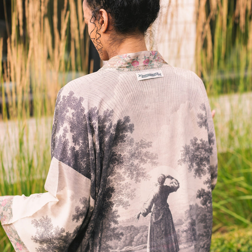 
                  
                    Model wearing our Still I Rise Pixie Duster with empowering message a bold, layered design featuring antique landscape etchings – Market of Stars
                  
                
