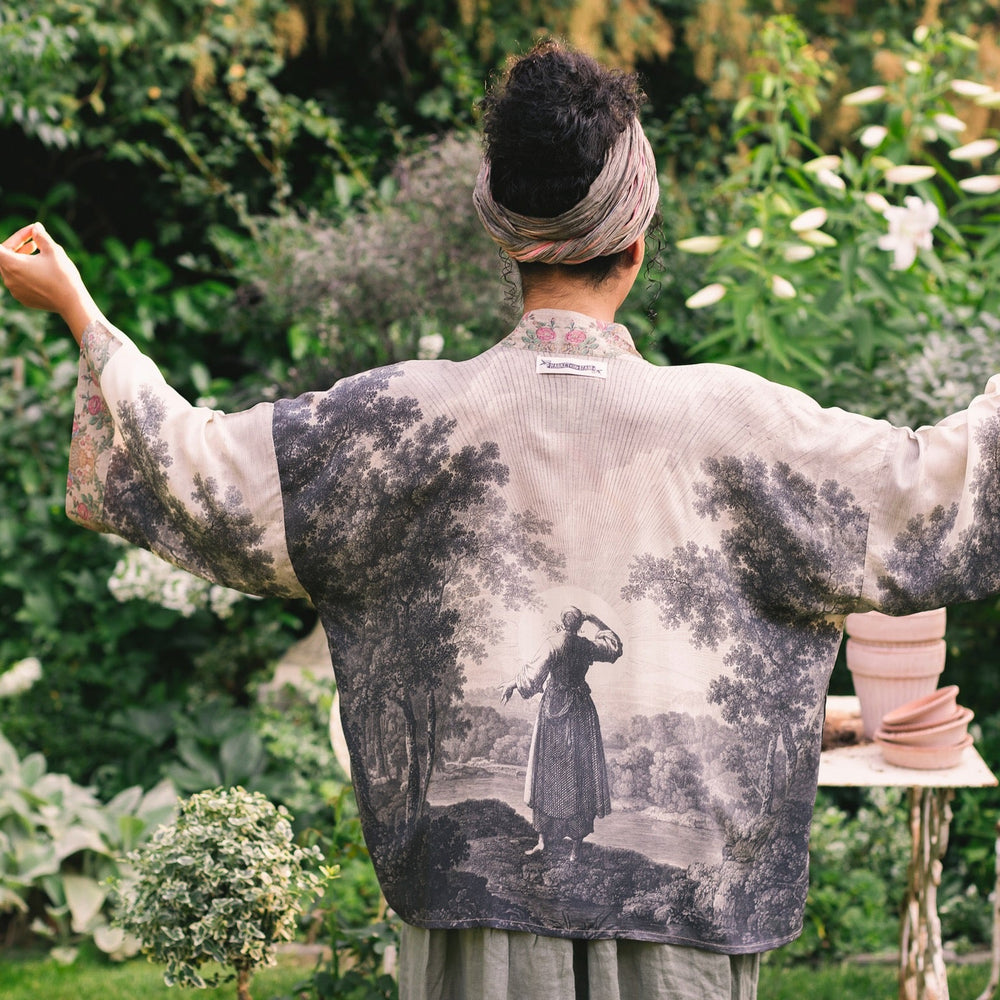 
                  
                    Model wearing our Still I Rise Pixie Duster with empowering message a bold, layered design featuring antique landscape etchings – Market of Stars
                  
                