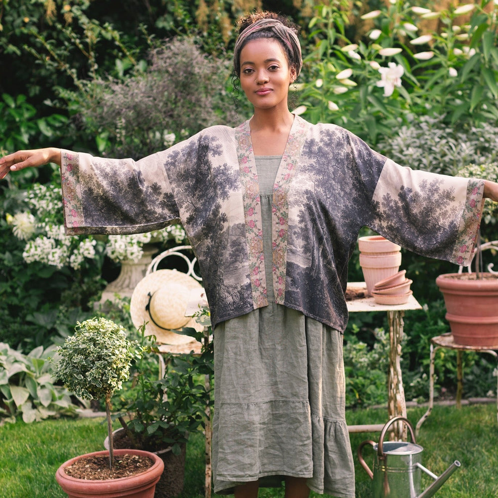 
                  
                    Model wearing our Still I Rise Pixie Duster with empowering message a bold, layered design featuring antique landscape etchings – Market of Stars
                  
                