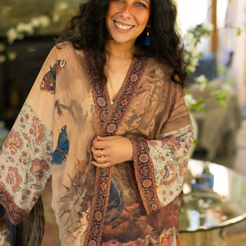 
                  
                    Model(s) wearing The Storyteller -- a mid-length Matinée kimono duster featuring antique artwork and vintage prints from around the world -- Market of Stars
                  
                