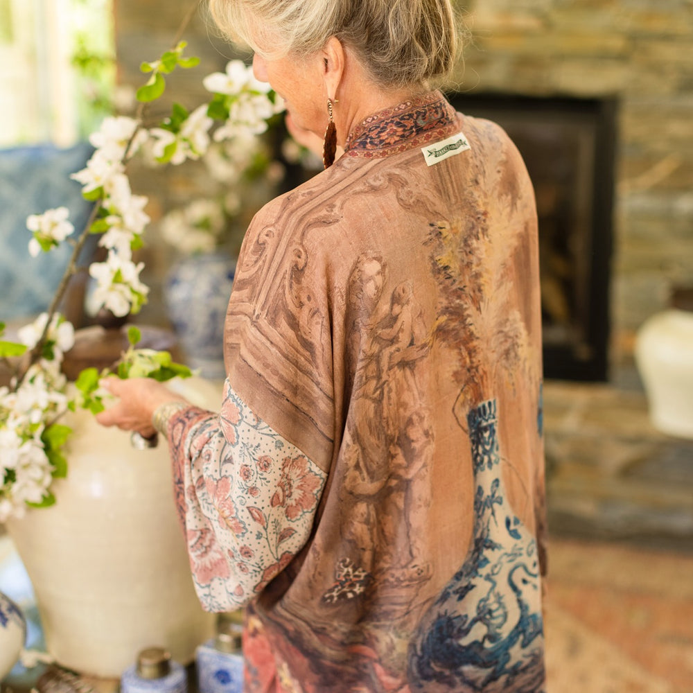 
                  
                    Model(s) wearing The Storyteller -- a mid-length Matinée kimono duster featuring antique artwork and vintage prints from around the world -- Market of Stars
                  
                