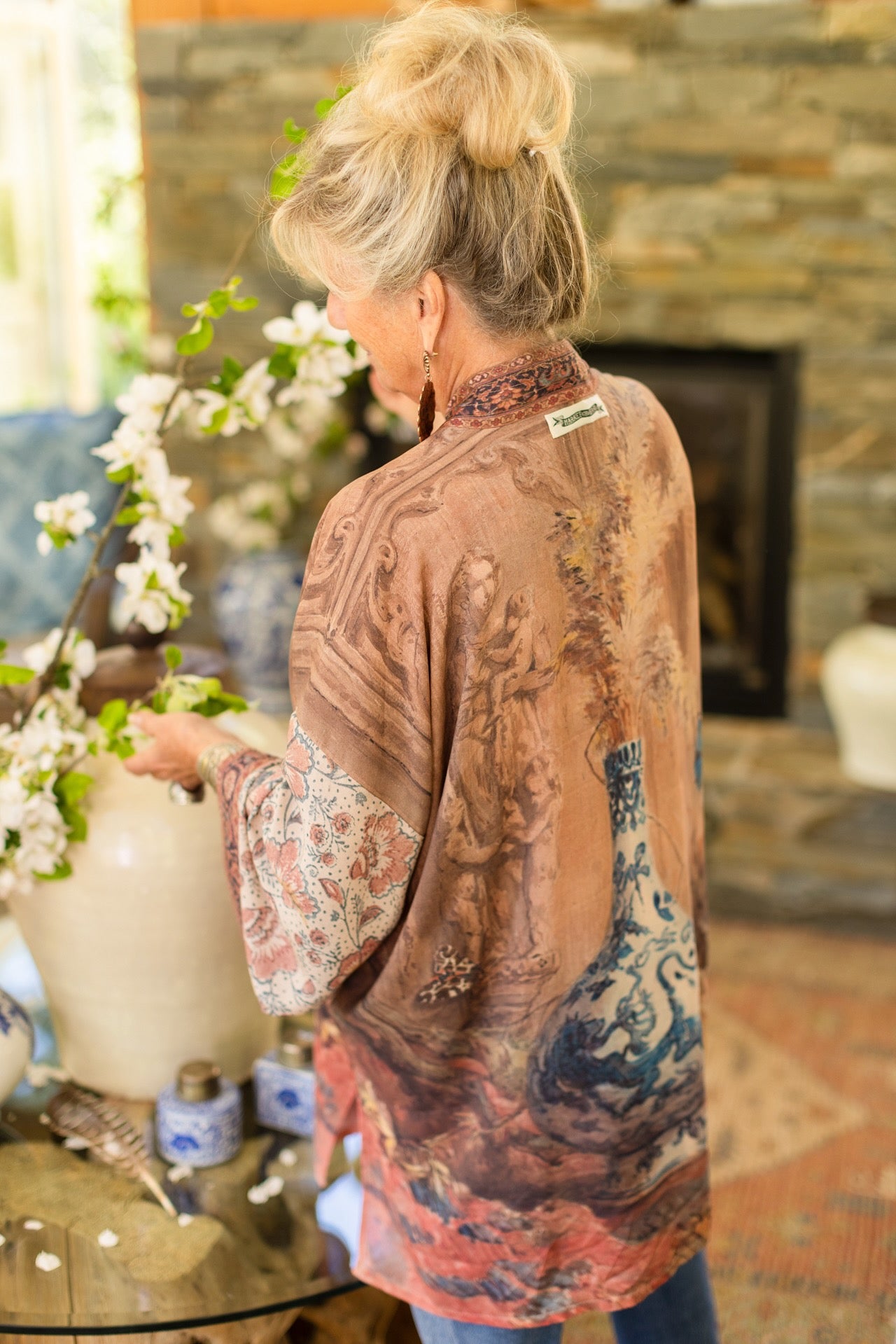 Model(s) wearing The Storyteller -- a mid-length Matinée kimono duster featuring antique artwork and vintage prints from around the world -- Market of Stars