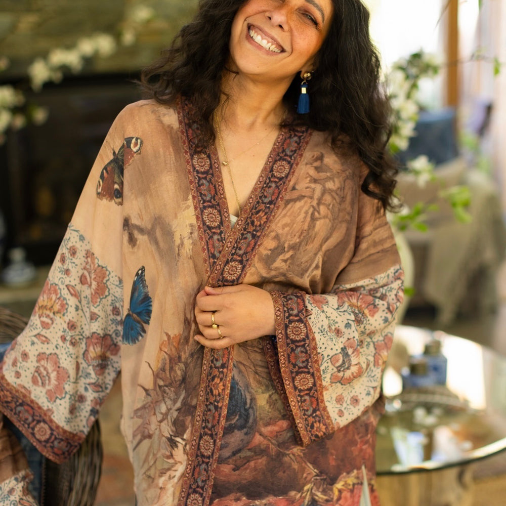 
                  
                    Model(s) wearing The Storyteller -- a mid-length Matinée kimono duster featuring antique artwork and vintage prints from around the world -- Market of Stars
                  
                