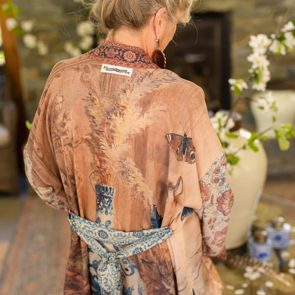 
                  
                    Model(s) wearing The Storyteller -- a mid-length Matinée kimono duster featuring antique artwork and vintage prints from around the world -- Market of Stars
                  
                